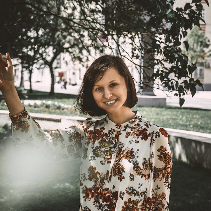Mira Chen, Lead Design Curator at HarborPlainSoft, reviewing corporate floral arrangements